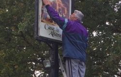 Cleaning The Pub Sign